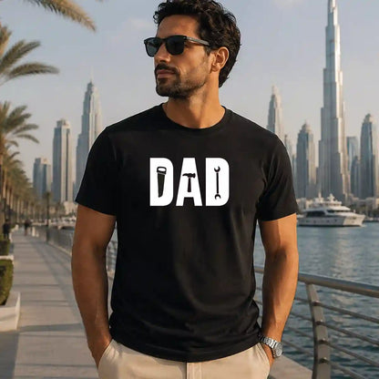 Dad wearing black DAD tools graphic t-shirt featuring saw, hammer and wrench design, Father's Day gift shirt, Dubai UAE.