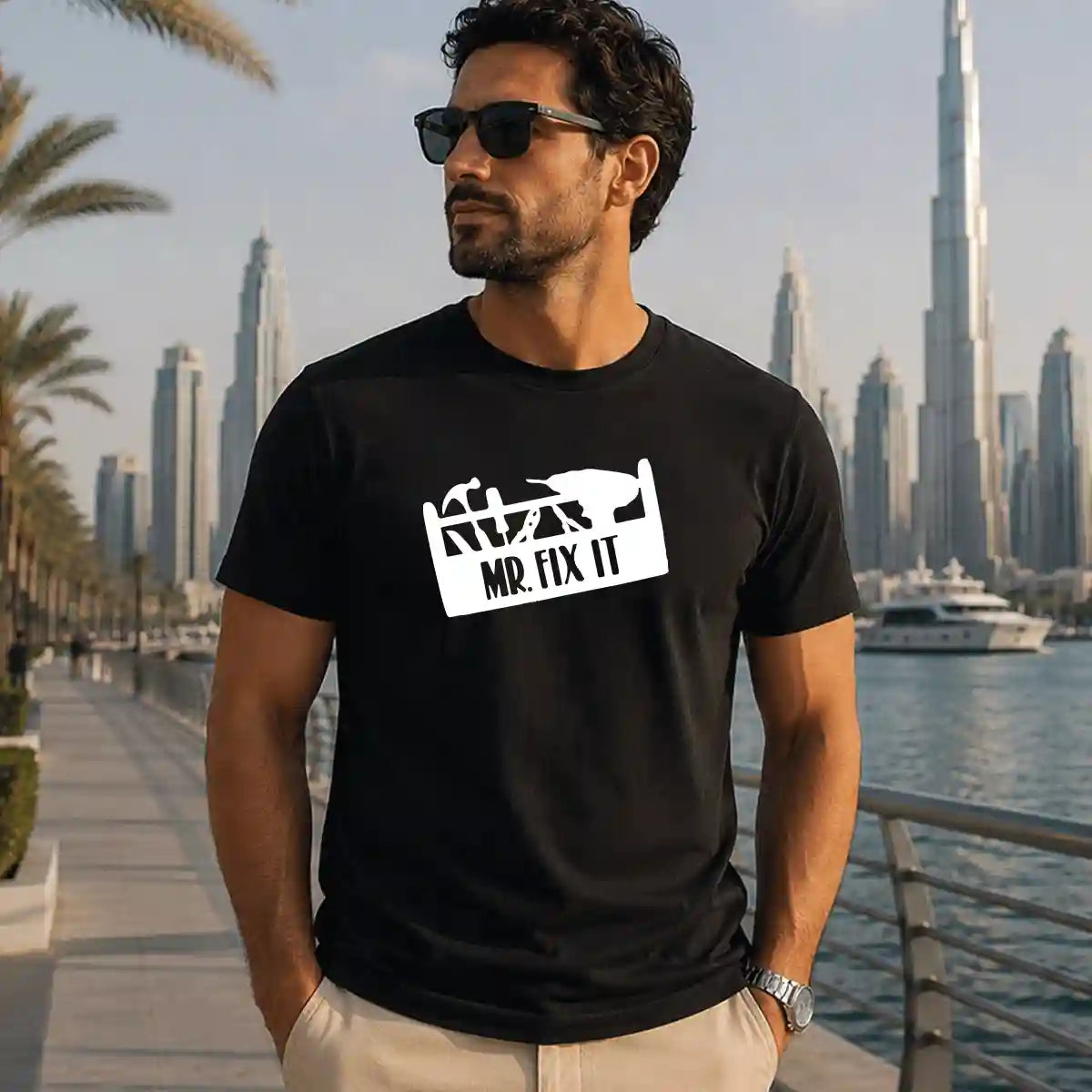 Man wearing black "Mr. Fix It" printed t-shirt, funny handyman dad shirt, Father's Day gift for DIY dads, Dubai UAE lifestyle.
