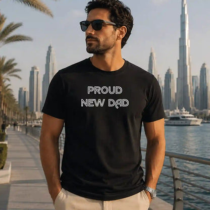 Black t-shirt featuring “Proud New Dad” print, pregnancy announcement design for expecting fathers, comfortable casual wear, ideal gift for new dads in UAE.
