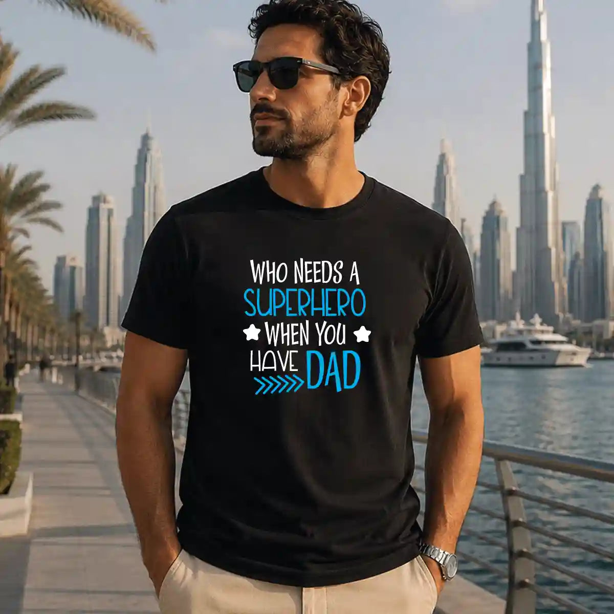 Black t-shirt featuring a “Superhero Dad” graphic print, comfortable cotton casual wear for fathers, ideal gift for dads, Father’s Day, and everyday lifestyle use in the UAE.